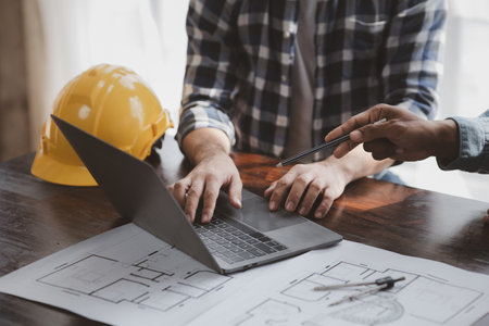 The home design architects are reviewing the house plan draft, the project commissioned by the...