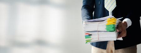 Businessman working, businessman looking at business documents and checking company finances, young startup company executive. Startup business management concept.の写真素材