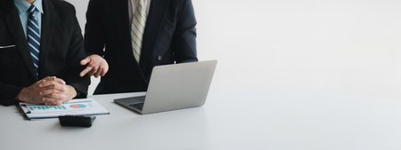 The sales department is having a monthly summary meeting to bring it to the department manager, they are verifying the correctness of the documents that are prepared before bringing in to the managerの写真素材