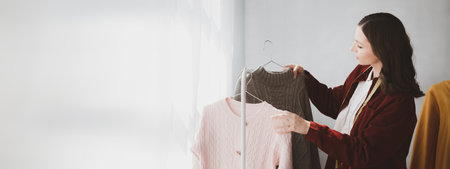 Beautiful girl clothing designer, the owner of the shop, she is the owner of a female fashion clothing store and designs clothes by herself, selling products through online websites.の写真素材