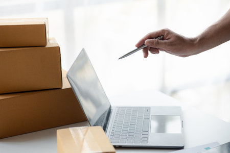 Owner online store on the website, selling products through the website, selling platforms, packing and delivering products according to orders, orders and delivery through private shipping companies.の写真素材