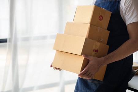 Owner online store on the website, selling products through the website, selling platforms, packing and delivering products according to orders, orders and delivery through private shipping companies.の写真素材