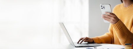 Asian woman business owner holding mobile phone View ordering information through the online website...
