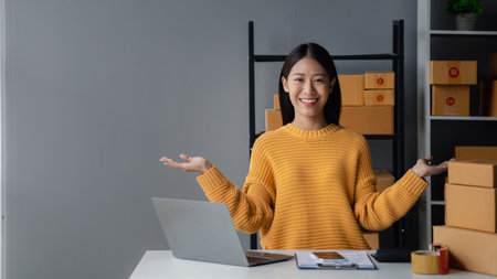 A beautiful business owner opens an online store, she is checking orders from customers, sending...