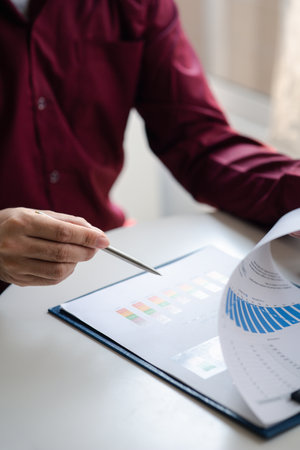 A financier is reviewing company financial documents, monthly financial statement summary from the finance department. The concept of managing the company's finances for accuracy and growth.の写真素材