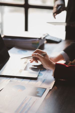 The sales department is having a monthly summary meeting to bring it to the department manager, they are verifying the correctness of the documents that are prepared before bringing in to the managerの写真素材