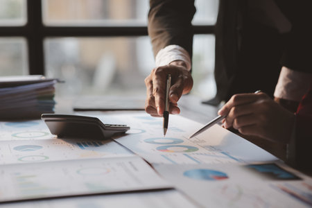 Group business people are reviewing monthly sales documents analysis and marketing plans for more sales growth, they are the founders of young companies co-founding startups. Sales management concept.の写真素材