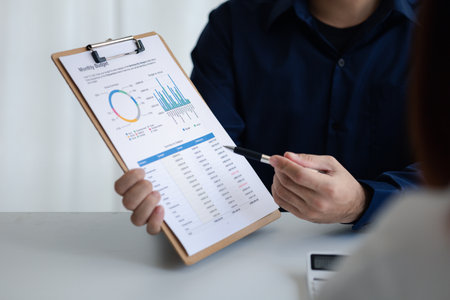 Group business people are brainstorming together and reviewing the company financial documents that the finance department has summarized, they are business partners. Business administration concept.の写真素材