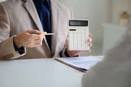 Real estate agents explain models of housing estates in projects to elaborate to clients, explaining and presenting information about homes and purchasing loans. Real estate trading concept.の写真素材