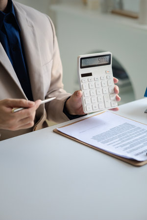 Real estate agents explain models of housing estates in projects to elaborate to clients, explaining and presenting information about homes and purchasing loans. Real estate trading concept.の写真素材