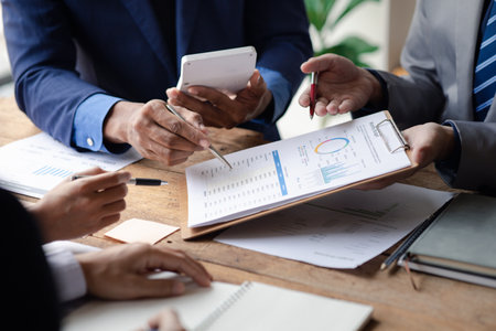 Businesswomen are opening up their laptop's financial information for business partnerships, they...