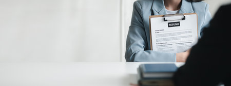 Person submitting resume to interview for a job with a company, Person attending a job interview with a manager to be recruited to the company for the position applied for. Job application concept.の写真素材