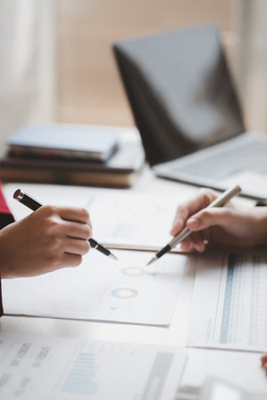 Two businessmen are brainstorming together and reviewing the company financial documents that the finance department has summarized, they are business partners. Business administration concept.の写真素材