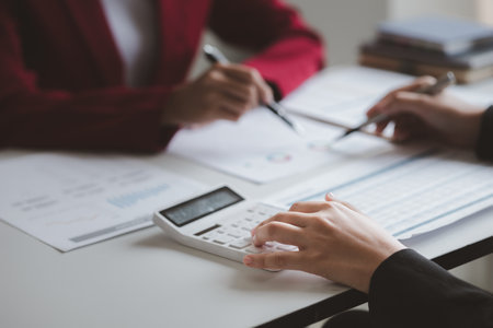 Two businessmen are brainstorming together and reviewing the company financial documents that the finance department has summarized, they are business partners. Business administration concept.の写真素材