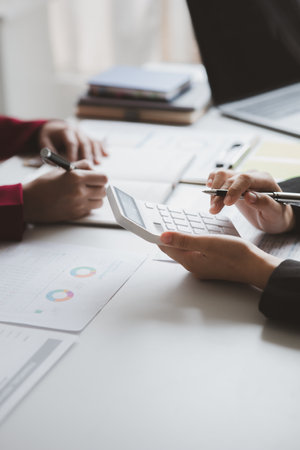 Two businessmen are brainstorming together and reviewing the company financial documents that the finance department has summarized, they are business partners. Business administration concept.の写真素材