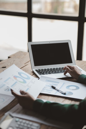 Business men are looking at the company's financial documents to analyze problems and find solutions before bringing the information to a meeting with a partner. Financial concept.の写真素材