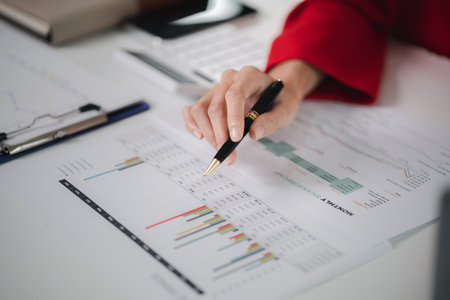 Company finance staff preparing financial documents, company finance staff preparing company finance documents to bring to the meeting to summarize for management's acknowledgment. Financial concept.の写真素材