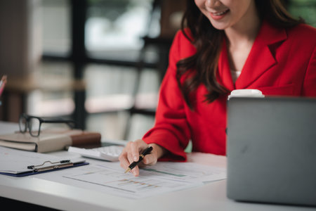 Company finance staff preparing financial documents, company finance staff preparing company finance documents to bring to the meeting to summarize for management's acknowledgment. Financial concept.の写真素材