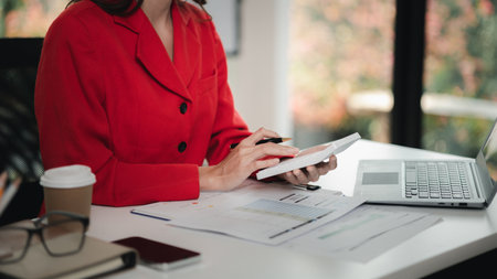 Company finance staff preparing financial documents, company finance staff preparing company finance documents to bring to the meeting to summarize for management's acknowledgment. Financial concept.の写真素材