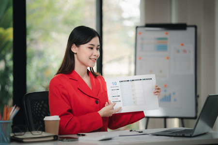 Beautiful Asian woman is a businesswoman who leads a new generation of startups, a woman who runs and manages a business plan to build confidence and stability in business, woman-led business concept.の写真素材