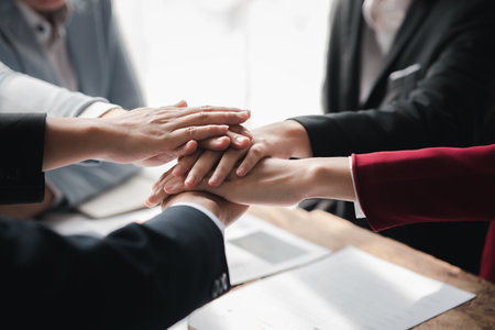 A group of business people joining hands, business meetings, startup company sales team meetings,...
