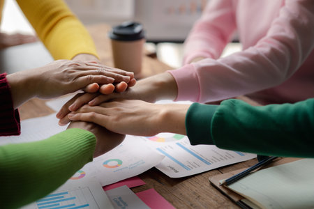 A group of startup businessmen joining hands, business meetings, startup company sales team meetings, brainstorming and summary of company performance. Business strategy management concept.の写真素材