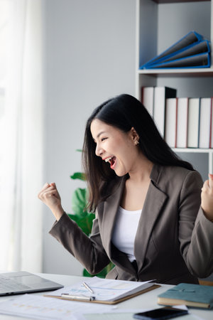 business woman making a happy gesture, young Asian business women as business executives, founding and running start-up executives, young female business leaders. Startup business concept.の写真素材
