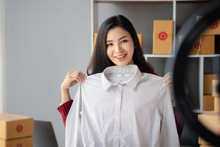 People are going live selling products, selling products online, packing orders from customers who order through online selling sites. Concept of selling products online and e-commerce.の写真素材