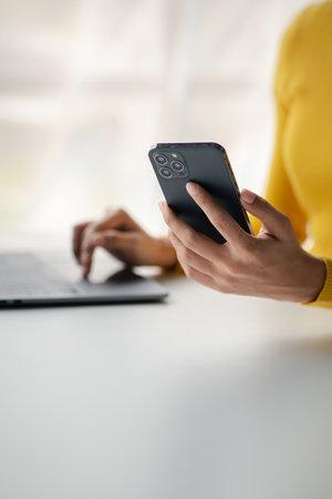 A person holds a mobile phone to use social media on a smartphone, communicating via the Internet on a smartphone. The concept of using technology in communication.の写真素材