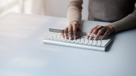 An individual is typing on a laptop keyboard showing a hologram interface to a member login, a businessman is going to access the company's membership system, check the information of the parties.の写真素材