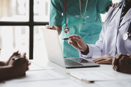 A conference room in a hospital where a group of doctors are attending a meeting, a meeting of executive doctors and chiefs meeting with pharmaceutical dealers. Doctor meeting concept.の写真素材