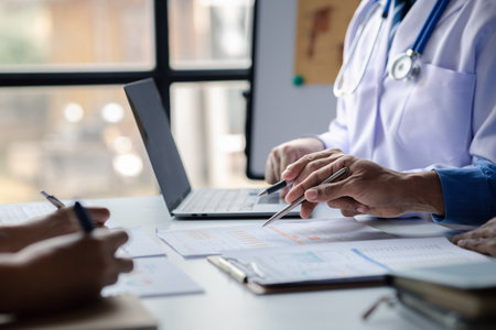 A conference room in a hospital where a group of doctors are attending a meeting, a meeting of executive doctors and chiefs meeting with pharmaceutical dealers. Doctor meeting concept.の写真素材