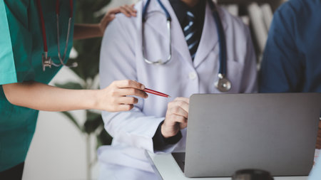 A conference room in a hospital where a group of doctors are attending a meeting, a meeting of executive doctors and chiefs meeting with pharmaceutical dealers. Doctor meeting concept.の写真素材
