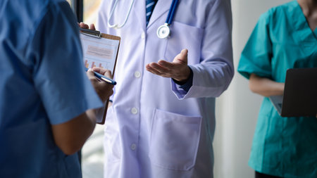 Two doctors stand in a conference room discussing, brainstorming on how to plan a patient's treatment in a complex case that requires careful planning. The concept of treating patients.の写真素材