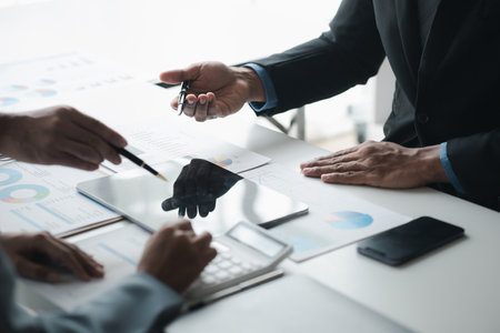 Atmosphere of a startup company meeting, business people are meeting together to summarize and plan investment finances, they are the founders of the company. Business administration concept.の写真素材