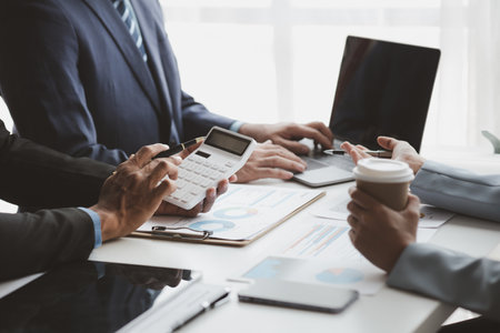 Atmosphere of a startup company meeting, business people are meeting together to summarize and plan investment finances, they are the founders of the company. Business administration concept.の写真素材