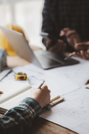 Group architects and engineers are in a meeting to discuss and inspect the house designs to meet the building and construction standards. Interior design and decoration ideas.の写真素材