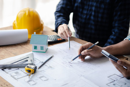 The home design architects are reviewing the house plan draft, the project commissioned by the client, and the custom design before delivery. Interior design and decoration ideas.の写真素材