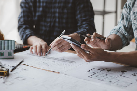 The home design architects are reviewing the house plan draft, the project commissioned by the client, and the custom design before delivery. Interior design and decoration ideas.の写真素材