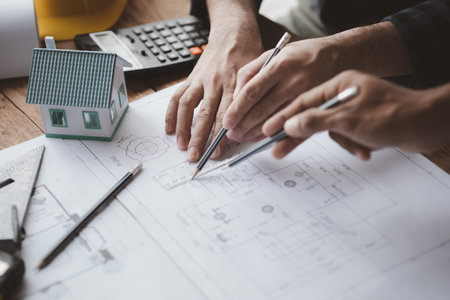 The home design architects are reviewing the house plan draft, the project commissioned by the client, and the custom design before delivery. Interior design and decoration ideas.の写真素材