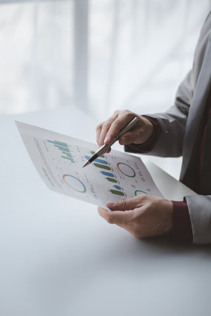 A financier is reviewing company financial documents, monthly financial statement summary from the finance department. The concept of managing the company's finances for accuracy and growth.の写真素材