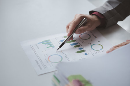 A financier is reviewing company financial documents, monthly financial statement summary from the finance department. The concept of managing the company's finances for accuracy and growth.の写真素材