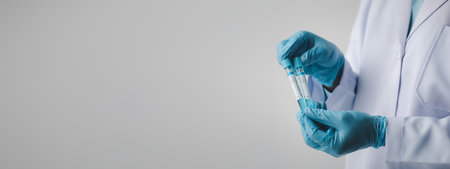 Lab assistant, a medical scientist, a chemistry researcher holds a glass tube through the blood...