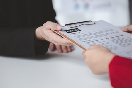 Person submitting resume to interview for a job with a company, Person attending a job interview with a manager to be recruited to the company for the position applied for. Job application concept.の写真素材