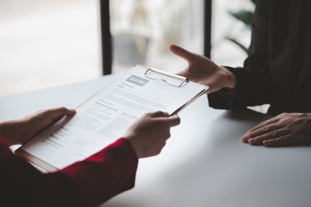 Person submitting resume to interview for a job with a company, Person attending a job interview with a manager to be recruited to the company for the position applied for. Job application concept.の写真素材
