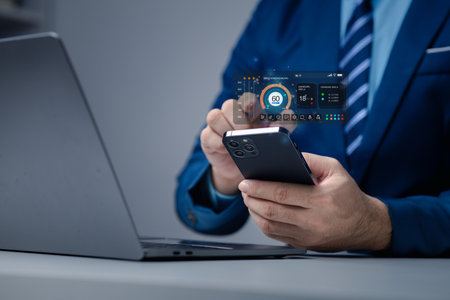 Businessman is holding smartphone with hologram, manipulating smartphone control, manipulating smartphone to suit user's usage.の写真素材