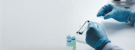 Lab assistant, medical scientist, chemistry researcher holds a glass tube through a chemical test...