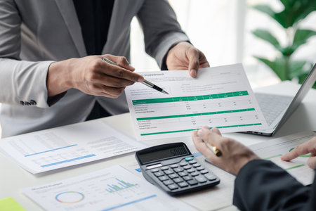 Executives and managers are meeting in a conference room, on the table there are some documents about the company's finances, managers are discussing financial information with the management.の写真素材