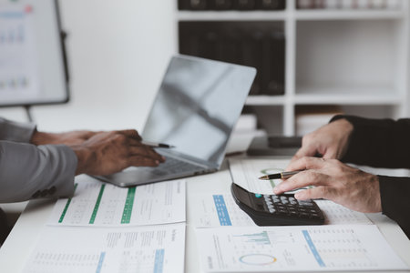 Executives and managers are meeting in a conference room, on the table there are some documents about the company's finances, managers are discussing financial information with the management.の写真素材