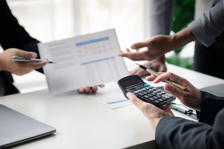 Meeting room atmosphere, business people meeting together on finance topics, they are working together to plan and solve corporate finance issues. Concept of business administration and finance.の写真素材